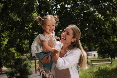 Photo of Happy mother with her daughter having fun in park
