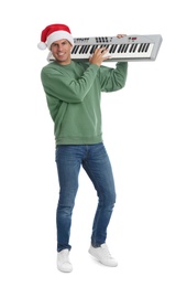 Photo of Man in Santa hat playing synthesizer on white background. Christmas music