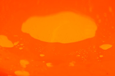 Photo of Delicious orange jelly as background, closeup view