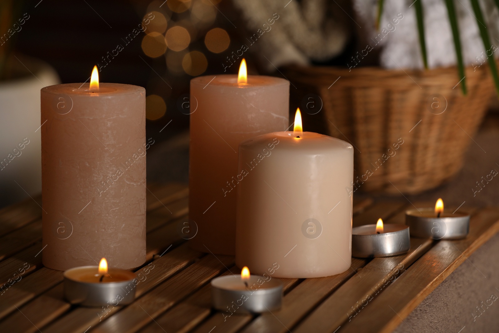 Photo of Spa composition with burning candles on massage table in wellness canter