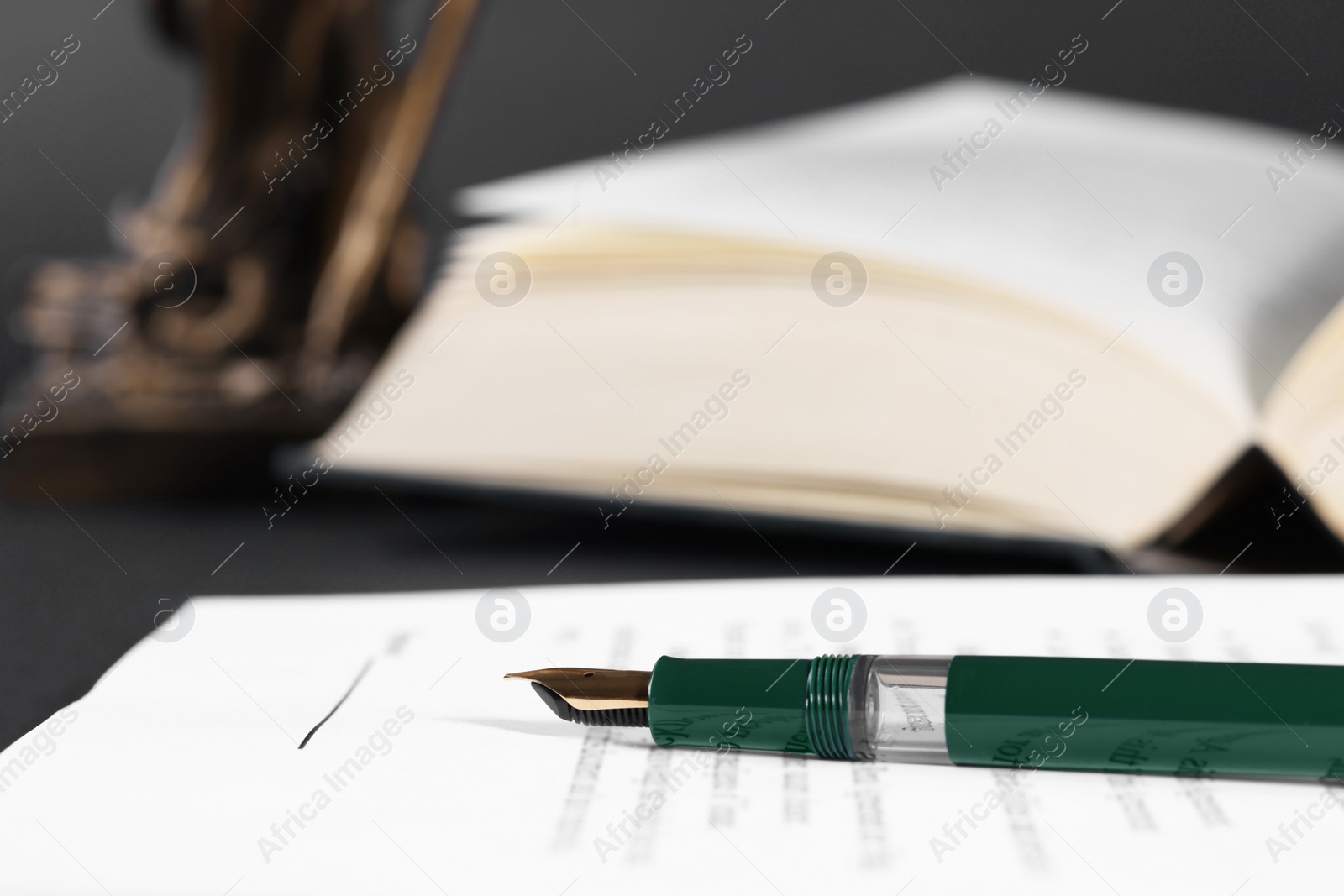 Photo of Fountain pen and paper document on table, closeup with space for text. Notary service