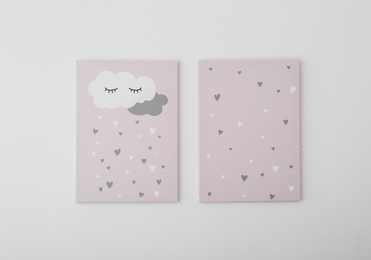 Photo of Adorable pictures of cloud and hearts on white wall. Children's room interior elements