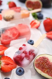 Photo of Tasty refreshing fruit and berry ice pops, closeup
