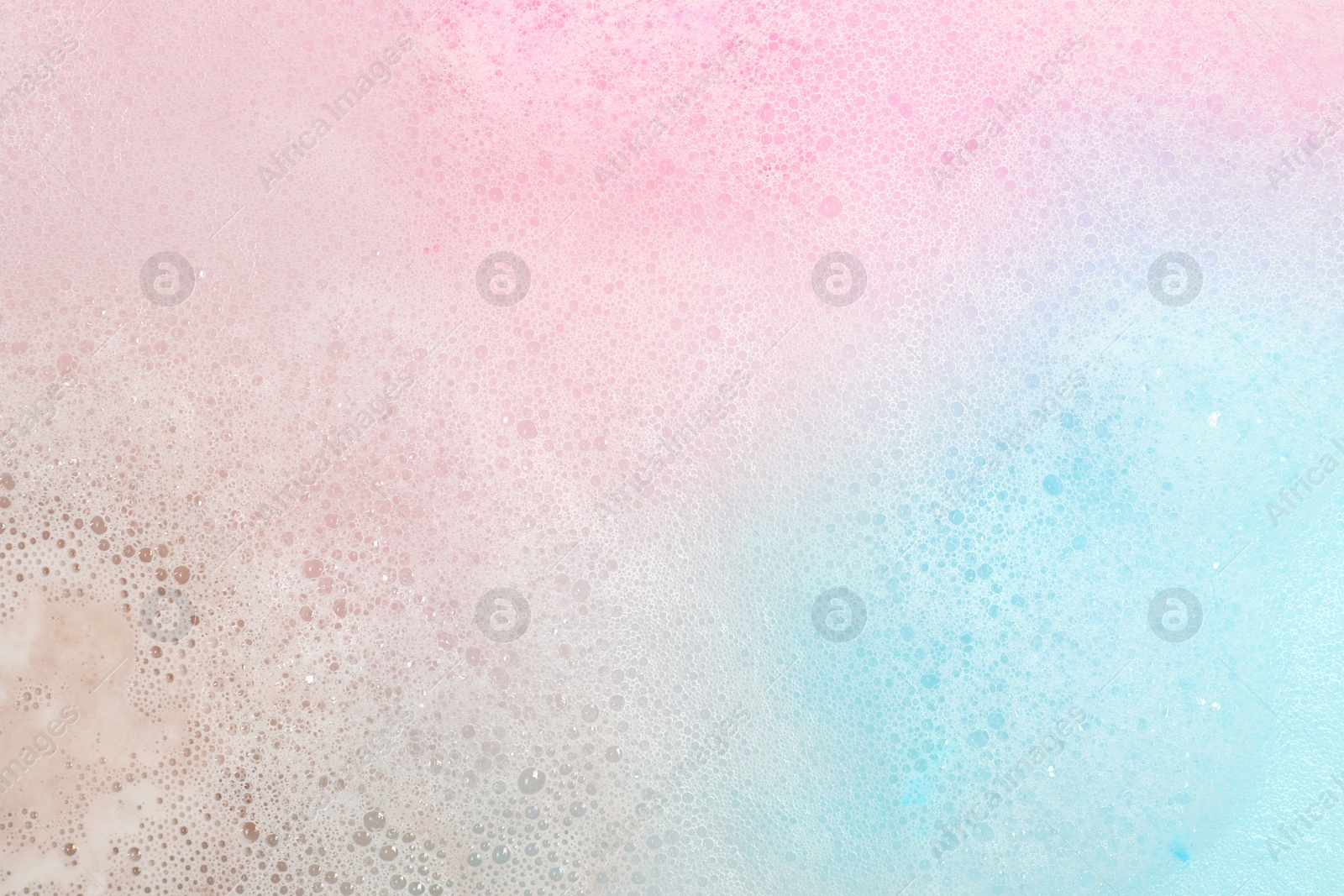 Photo of Colorful foam after dissolving bath bomb in water, closeup