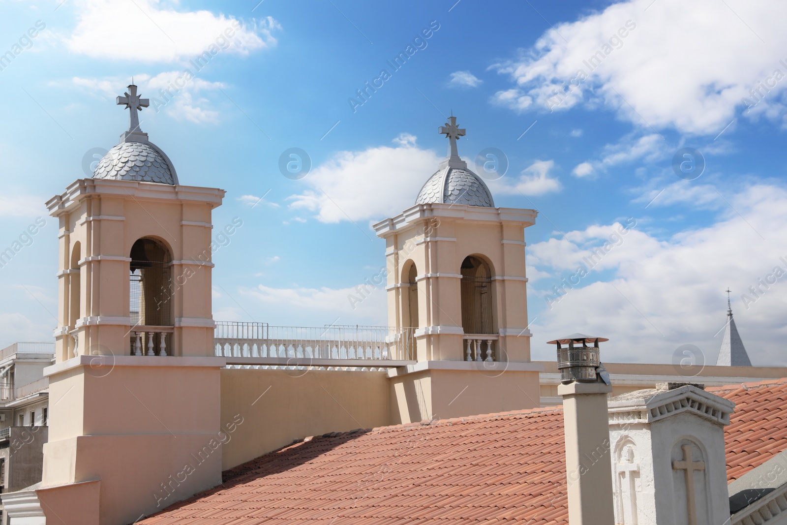 Photo of Beautiful church with red roof against blue sky