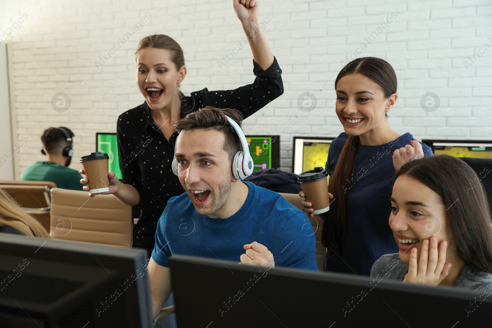 Photo of Young people playing video games on computers indoors. Esports tournament