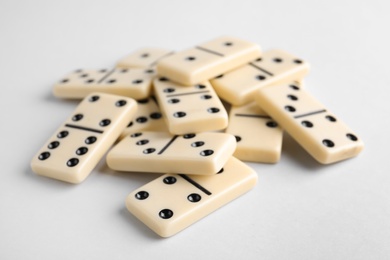 Photo of Pile of domino tiles on white background