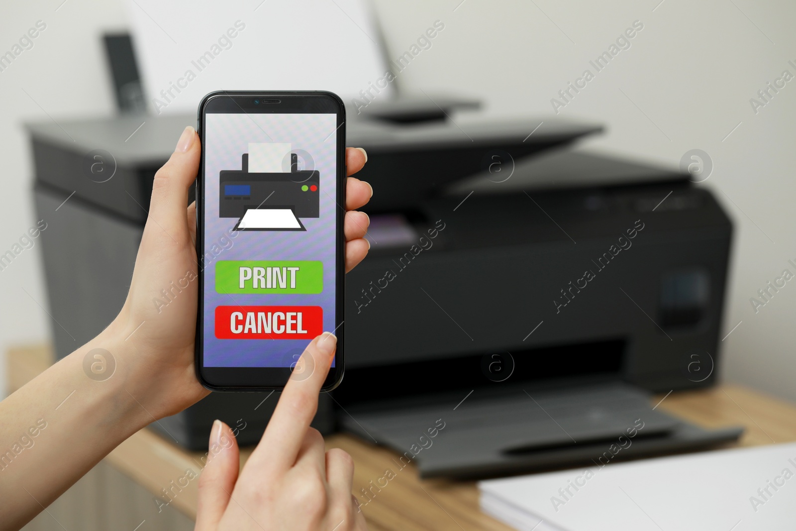 Photo of Woman using printer management application on smartphone indoors, closeup and space for text. Image on device screen.