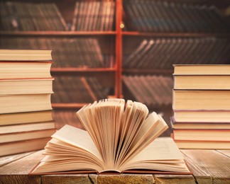 Different books on wooden table in library