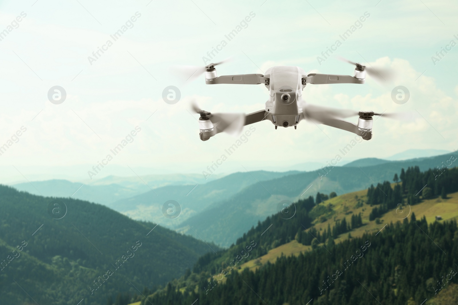 Image of Modern drone flying over picturesque mountains. Aerial survey