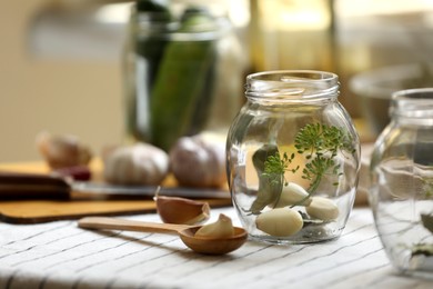 Empty glass jars and ingredients prepared for canning on table, closeup. Space for text