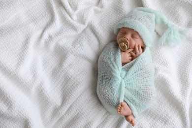 Photo of Cute newborn baby sleeping on white plaid, top view. Space for text