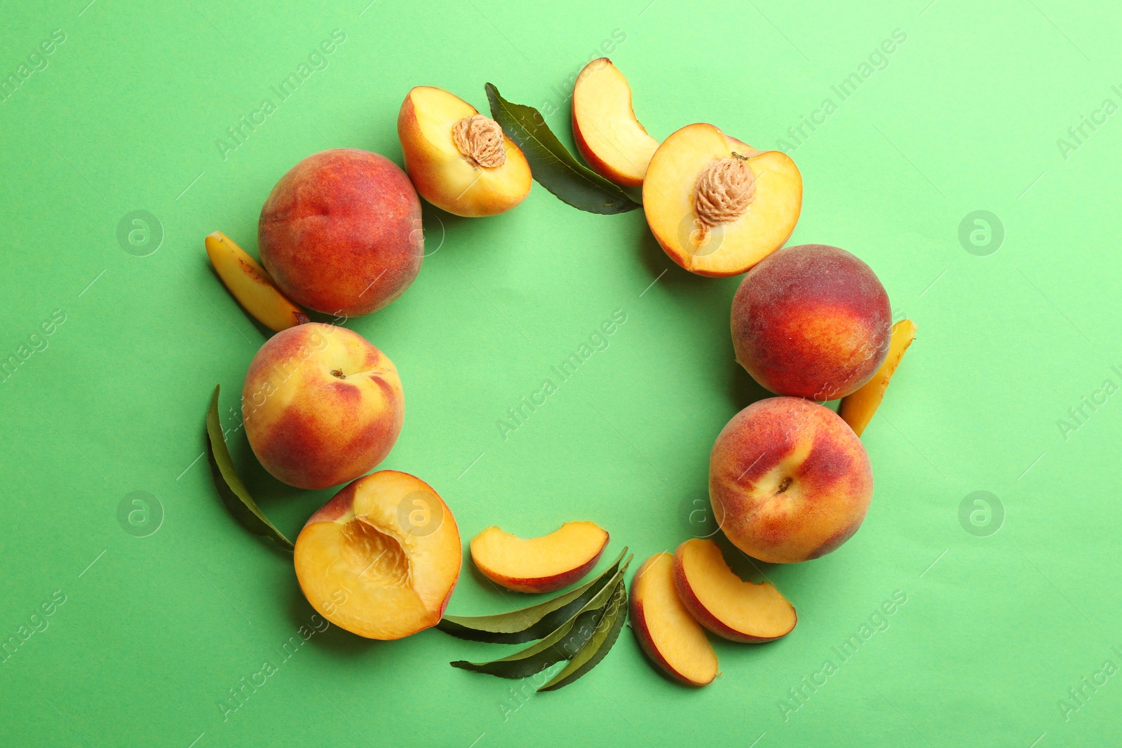 Photo of Flat lay composition with fresh peaches on green background. Space for text