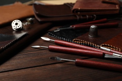 Photo of Leather samples and tools on wooden table