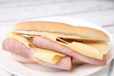 Photo of Delicious sandwich with ham and cheese on table, closeup