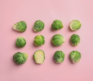 Fresh Brussels sprouts on pink background, flat lay