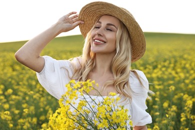 Portrait of happy young woman in field on spring day