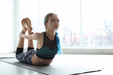 Young woman practicing yoga indoors