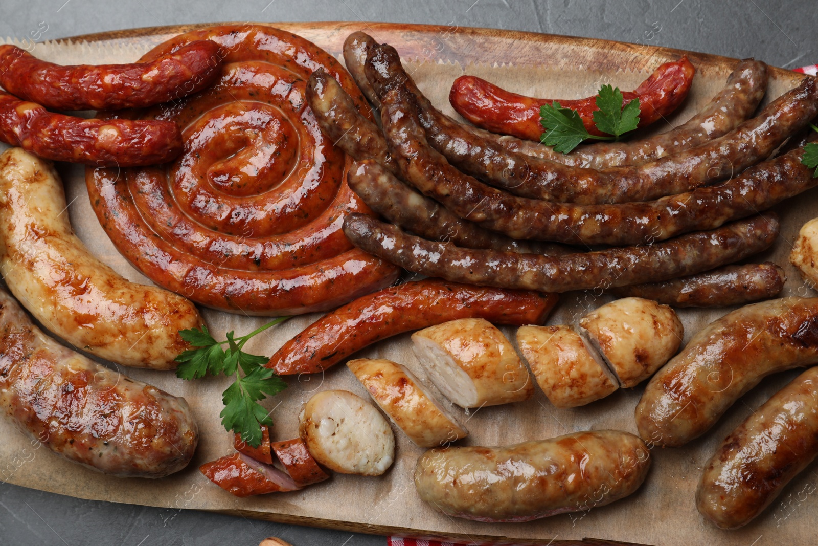 Photo of Set of different tasty snacks and beer on dark grey table, top view