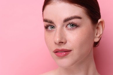 Photo of Portrait of beautiful woman on pink background, closeup. Space for text