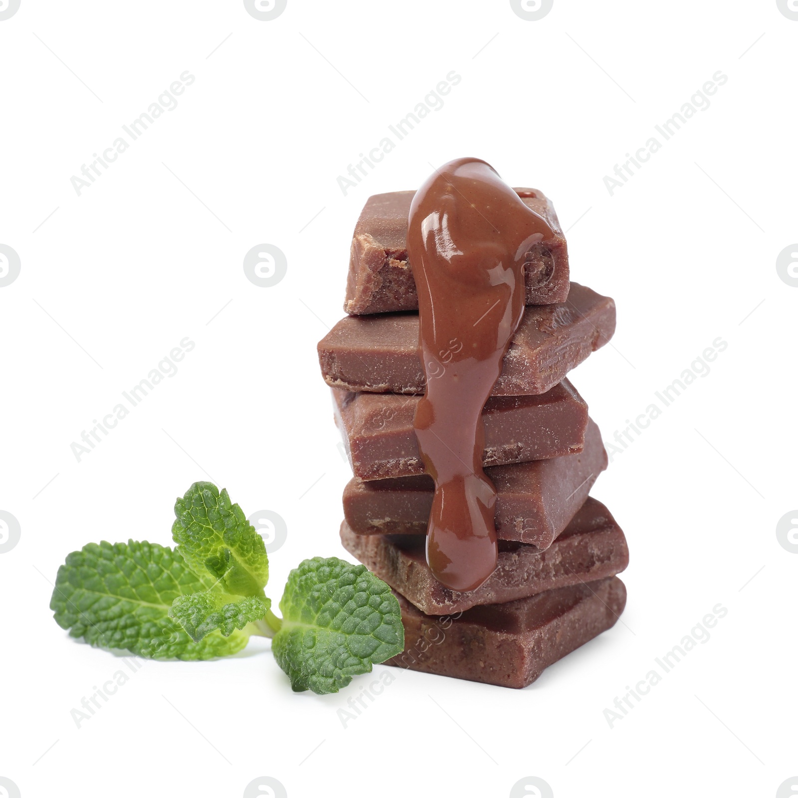 Photo of Pieces of milk chocolate with tasty paste and mint isolated on white