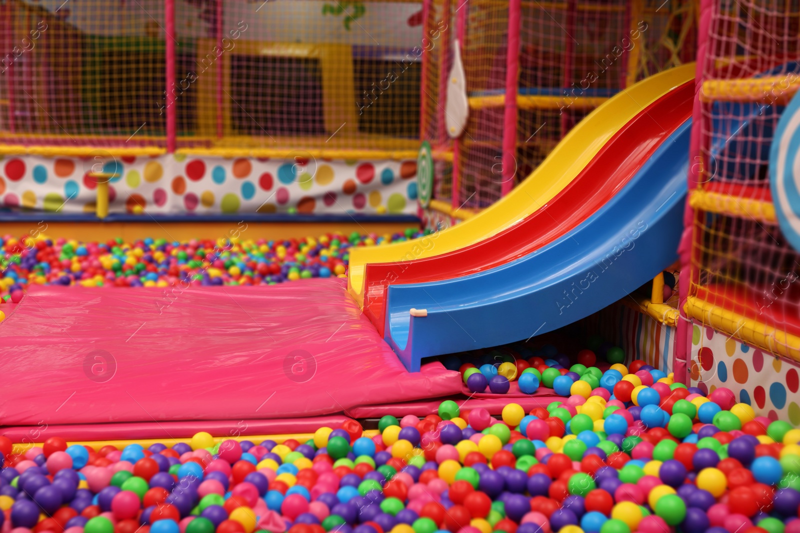 Photo of Slides and many colorful balls in ball pit