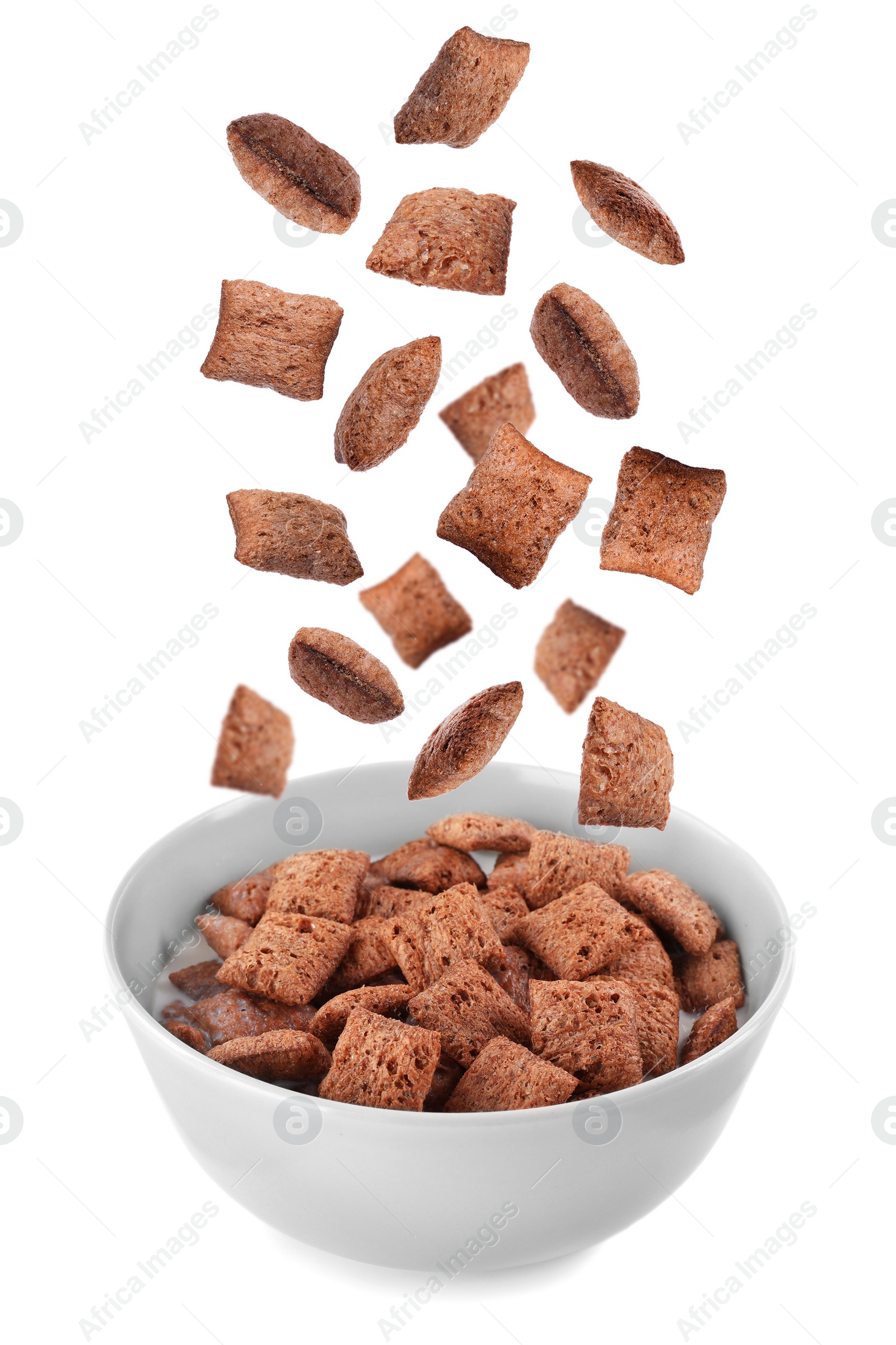 Image of Sweet crispy corn pads falling into bowl with milk on white background 