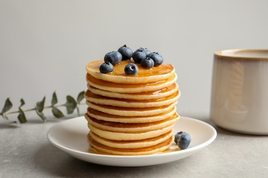 Plate with pancakes and berries on table