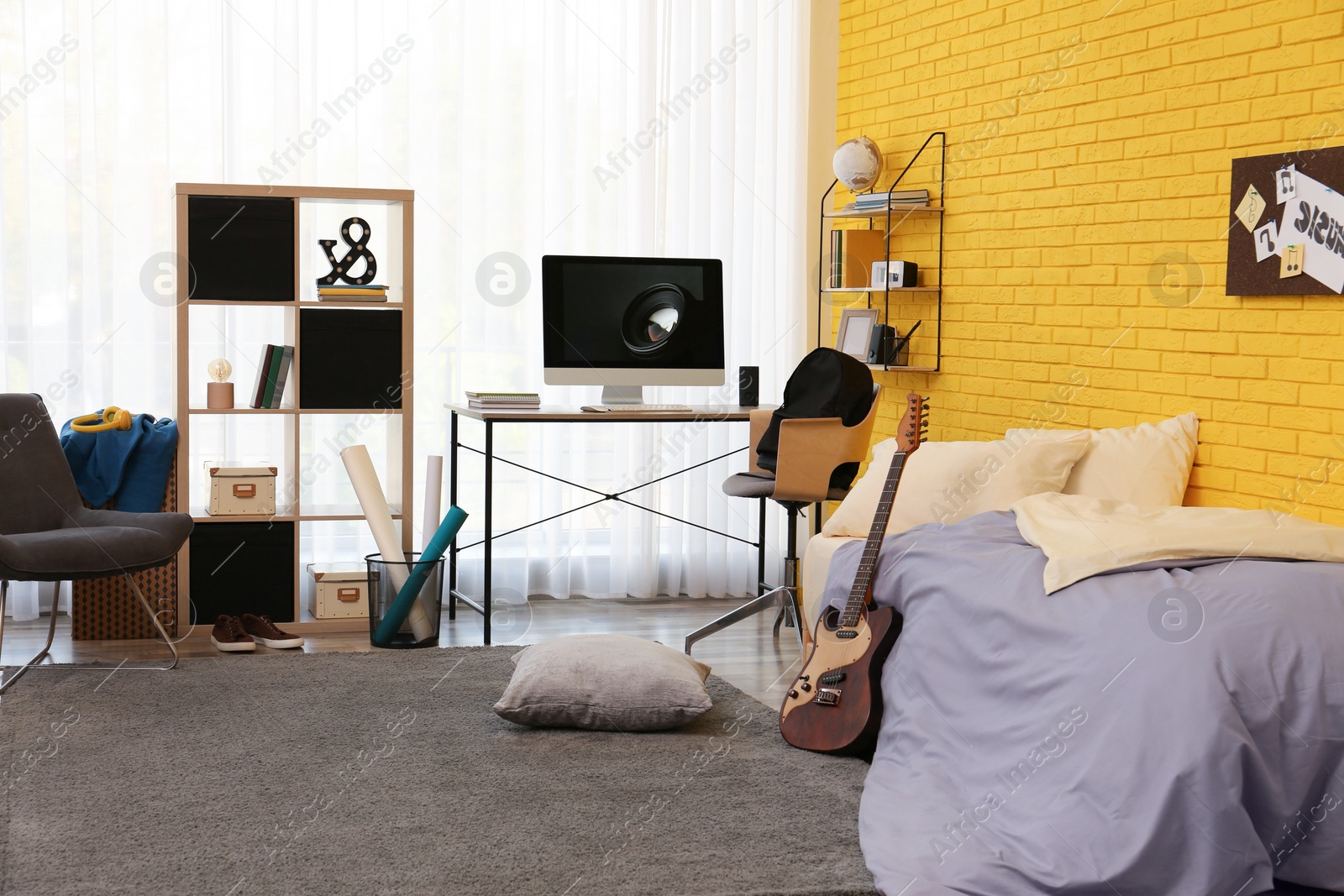 Photo of Stylish teenager's room interior with computer and bed