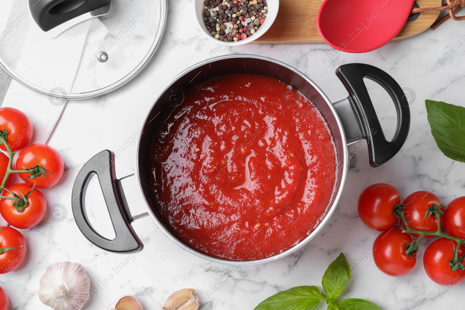 Photo of Delicious tomato sauce on white marble table, flat lay