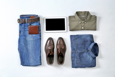Photo of Flat lay set of stylish male clothes and tablet on white background