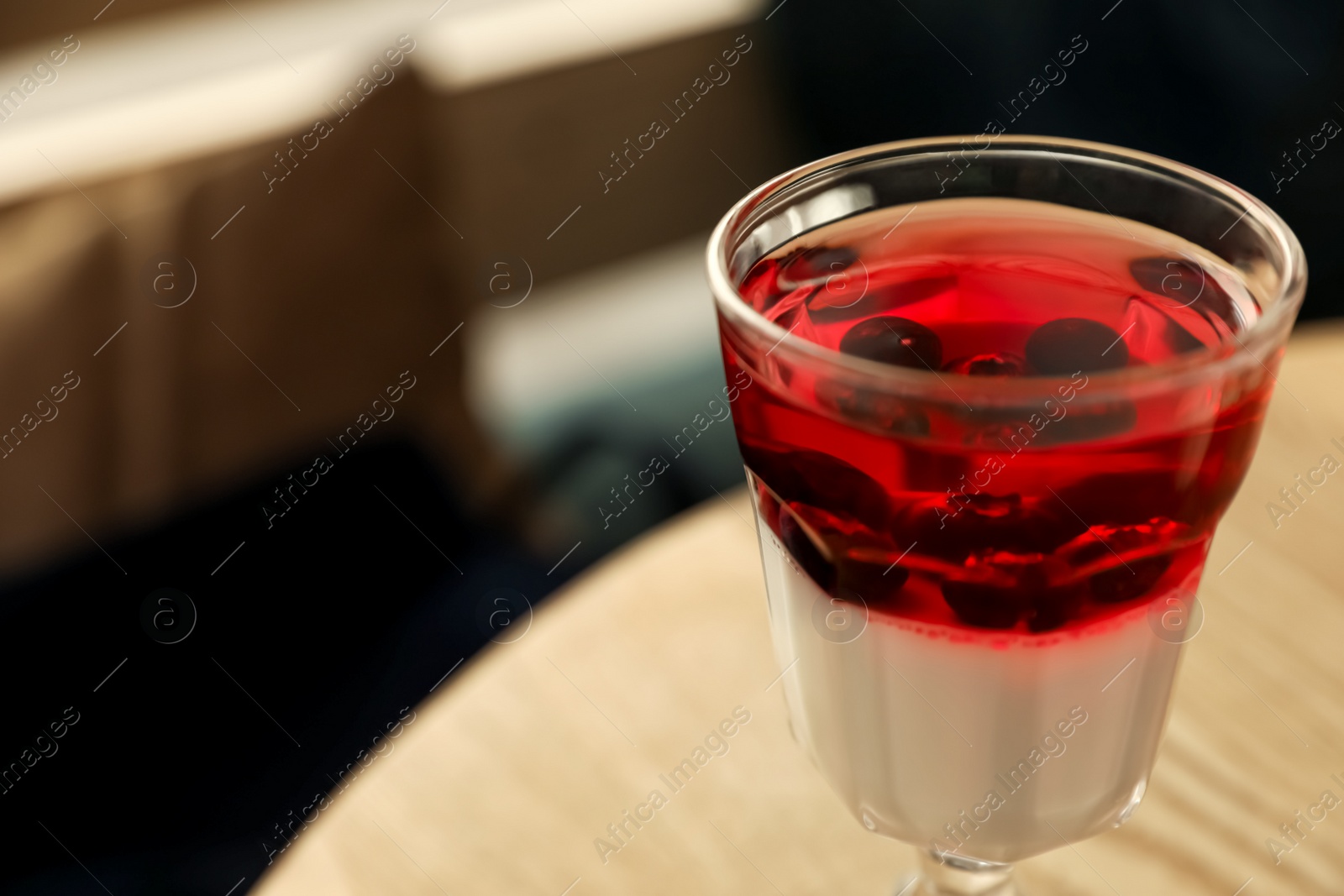 Photo of Delicious panna cotta dessert on wooden table, closeup. Space for text