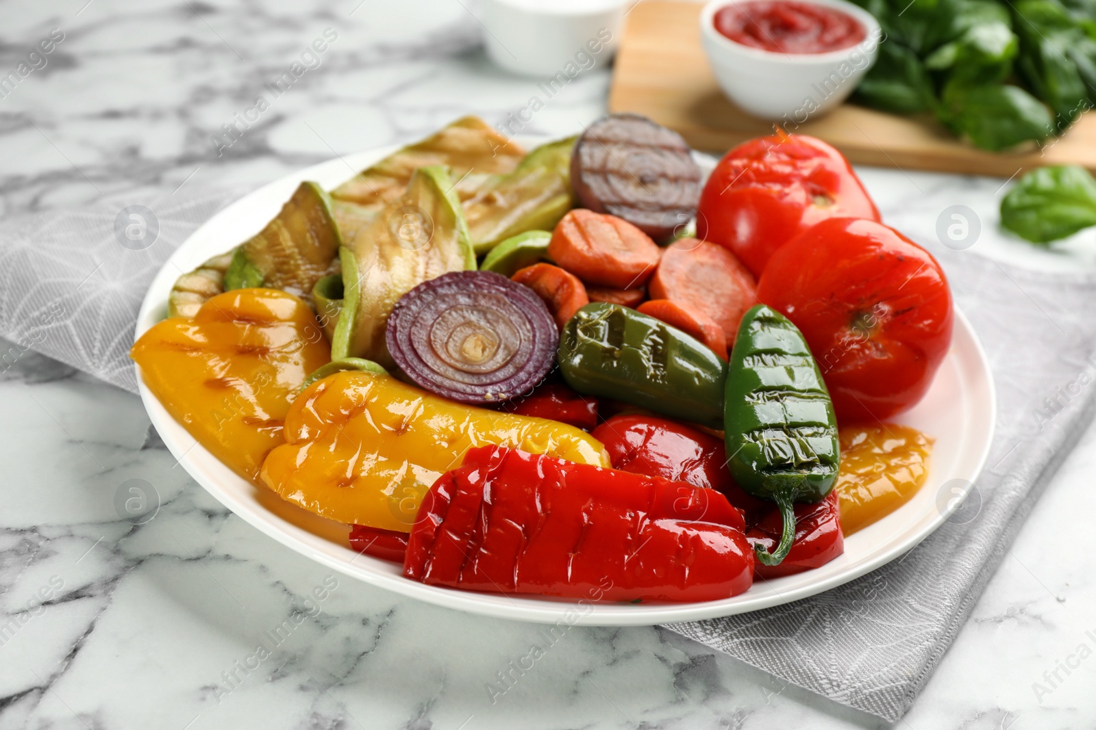 Photo of Delicious grilled vegetables on white marble table, closeup