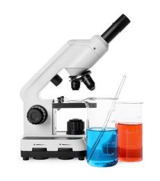 Laboratory glassware with colorful liquids and microscope isolated on white