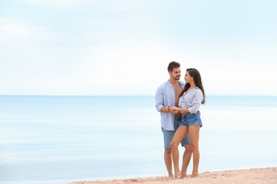 Happy young couple spending time together on beach