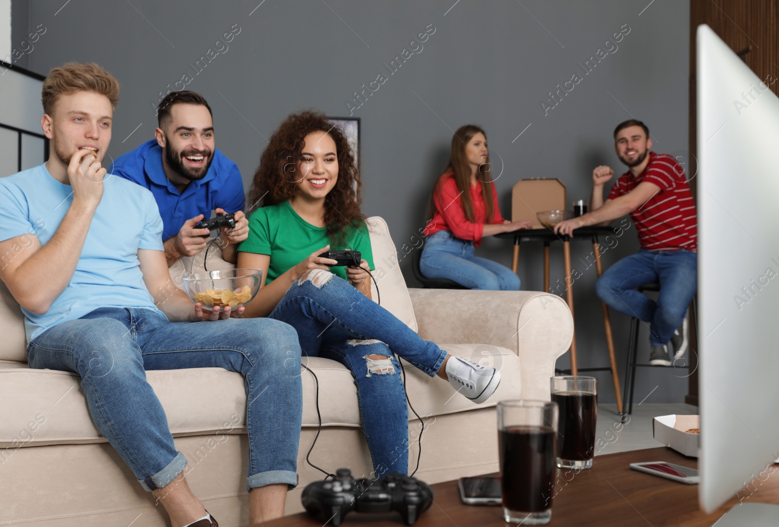 Photo of Emotional friends playing video games at home