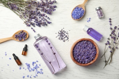 Flat lay composition with lavender flowers and natural cosmetic on wooden background