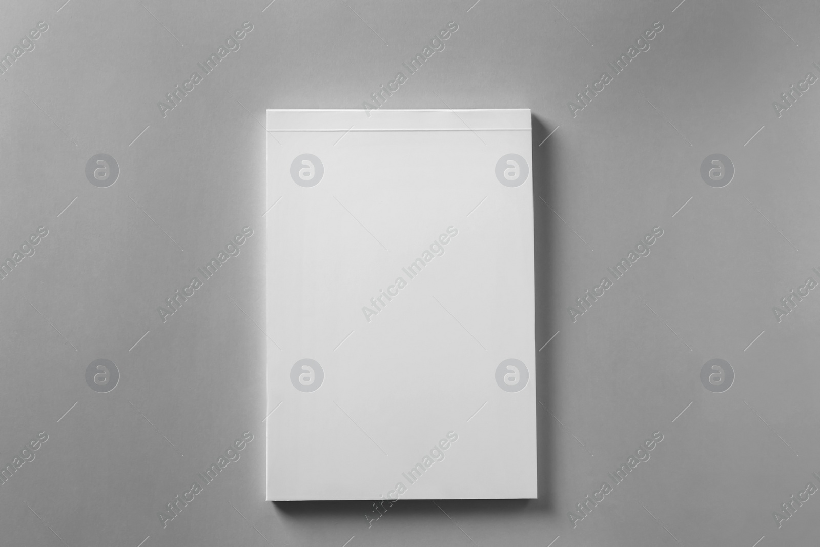 Photo of Brochure with blank cover on light grey background, top view