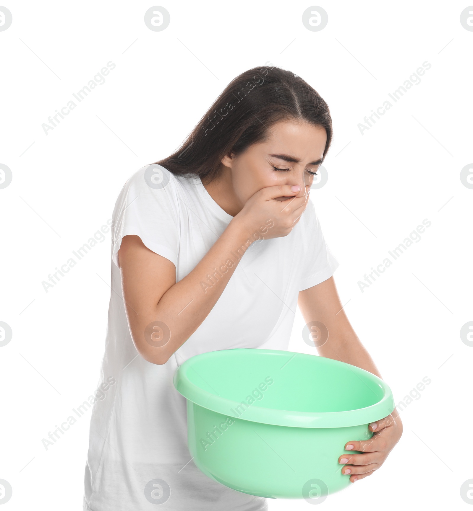 Photo of Young woman with basin suffering from nausea on white background. Food poisoning