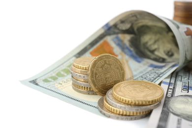 Dollar bills and coins on white background