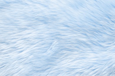 Texture of light blue faux fur as background, closeup