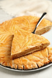 Traditional galette des rois on light grey marble table, closeup