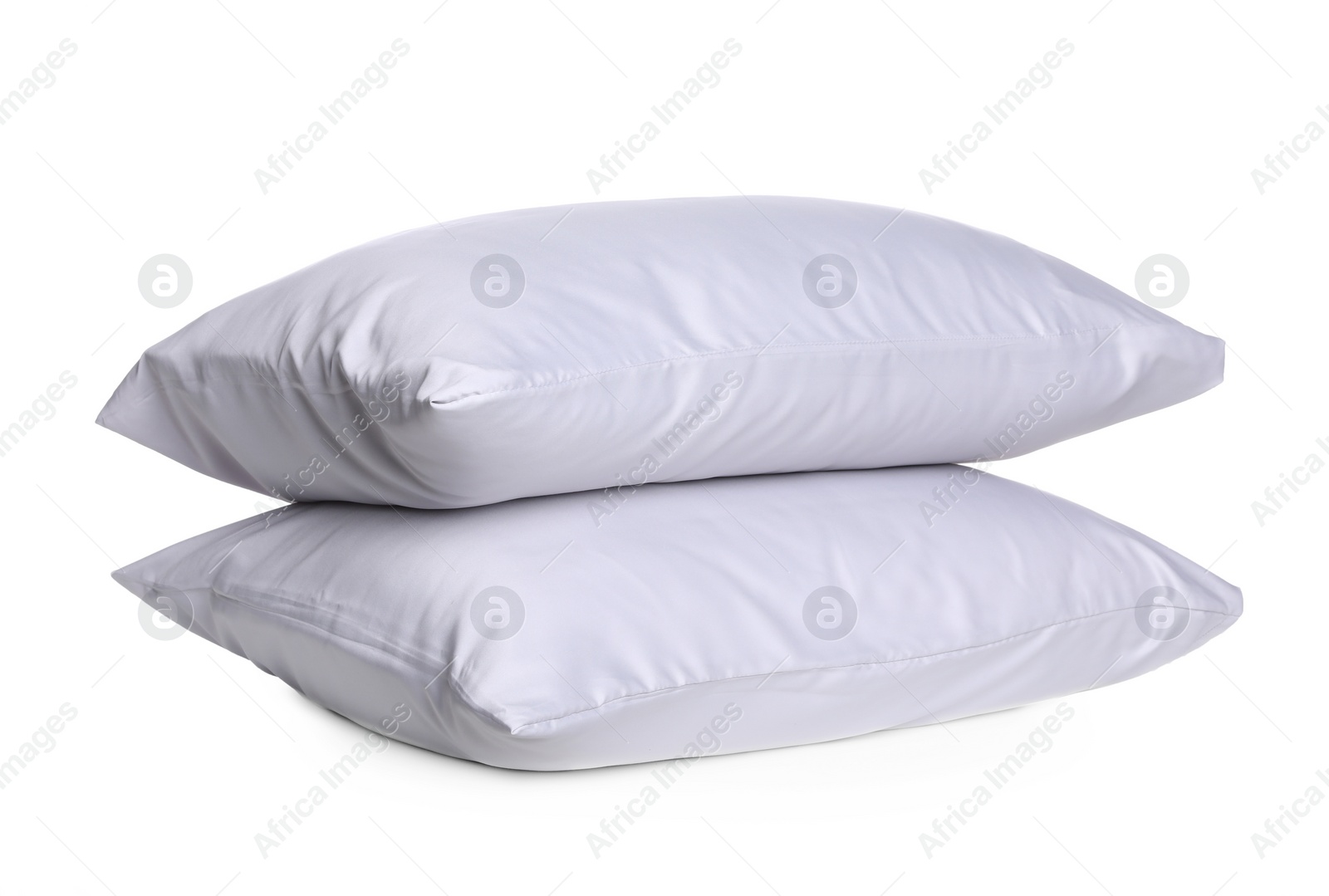 Photo of New soft bed pillows on white background. Silky linens