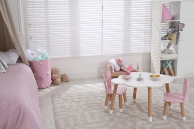 Cute child's room interior with toys and modern furniture