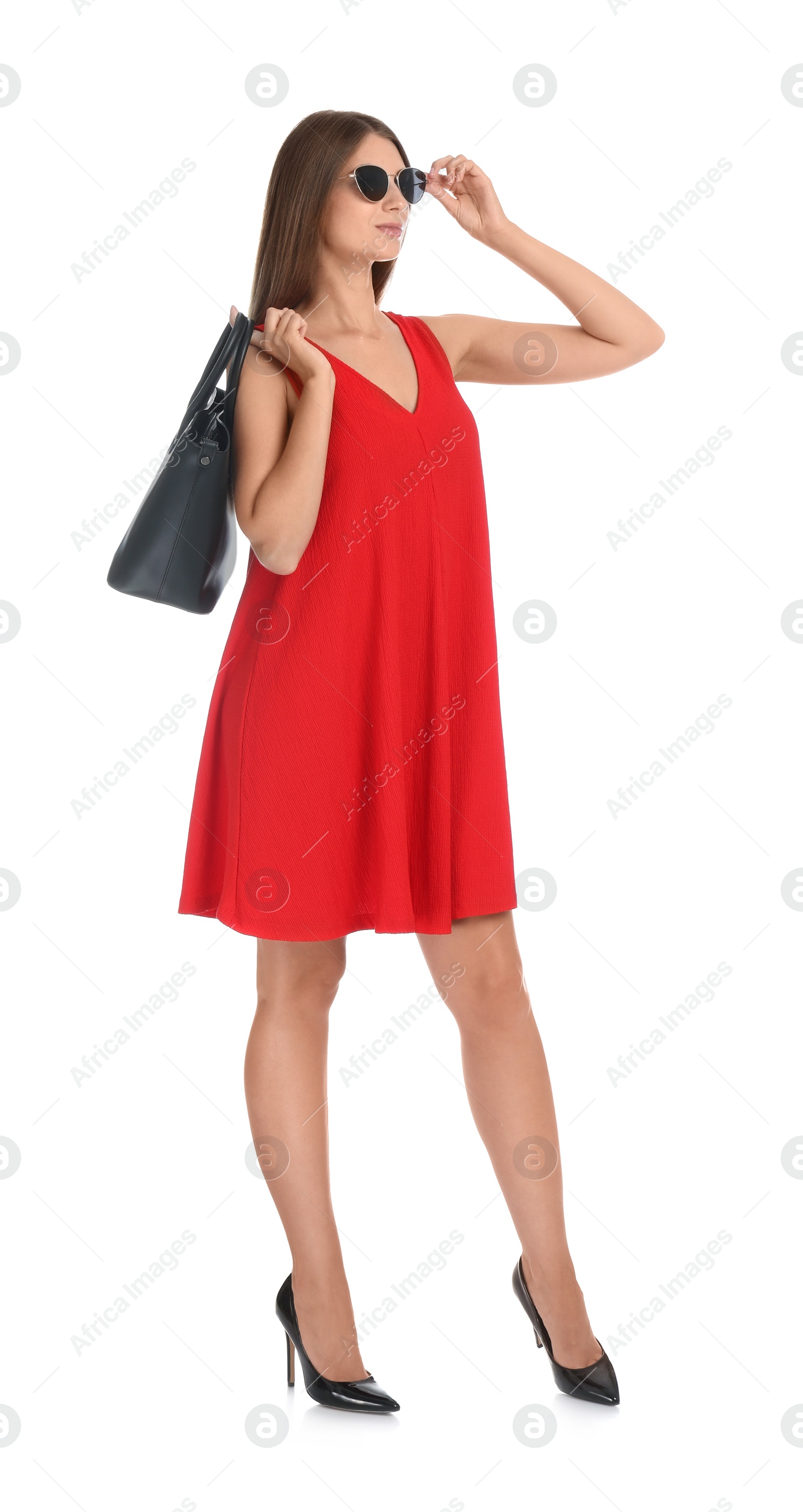 Photo of Young woman wearing stylish red dress with elegant bag on white background