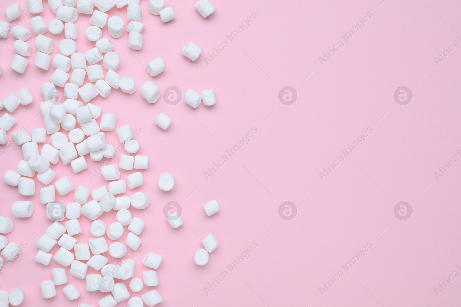 Photo of Delicious sweet marshmallows on pink background, flat lay. Space for text