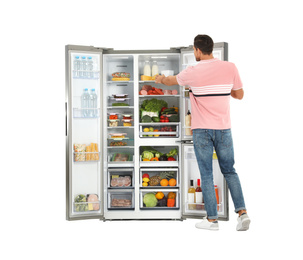 Man taking cheese from refrigerator on white background