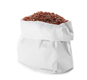 Photo of Bag with brown rice on white background