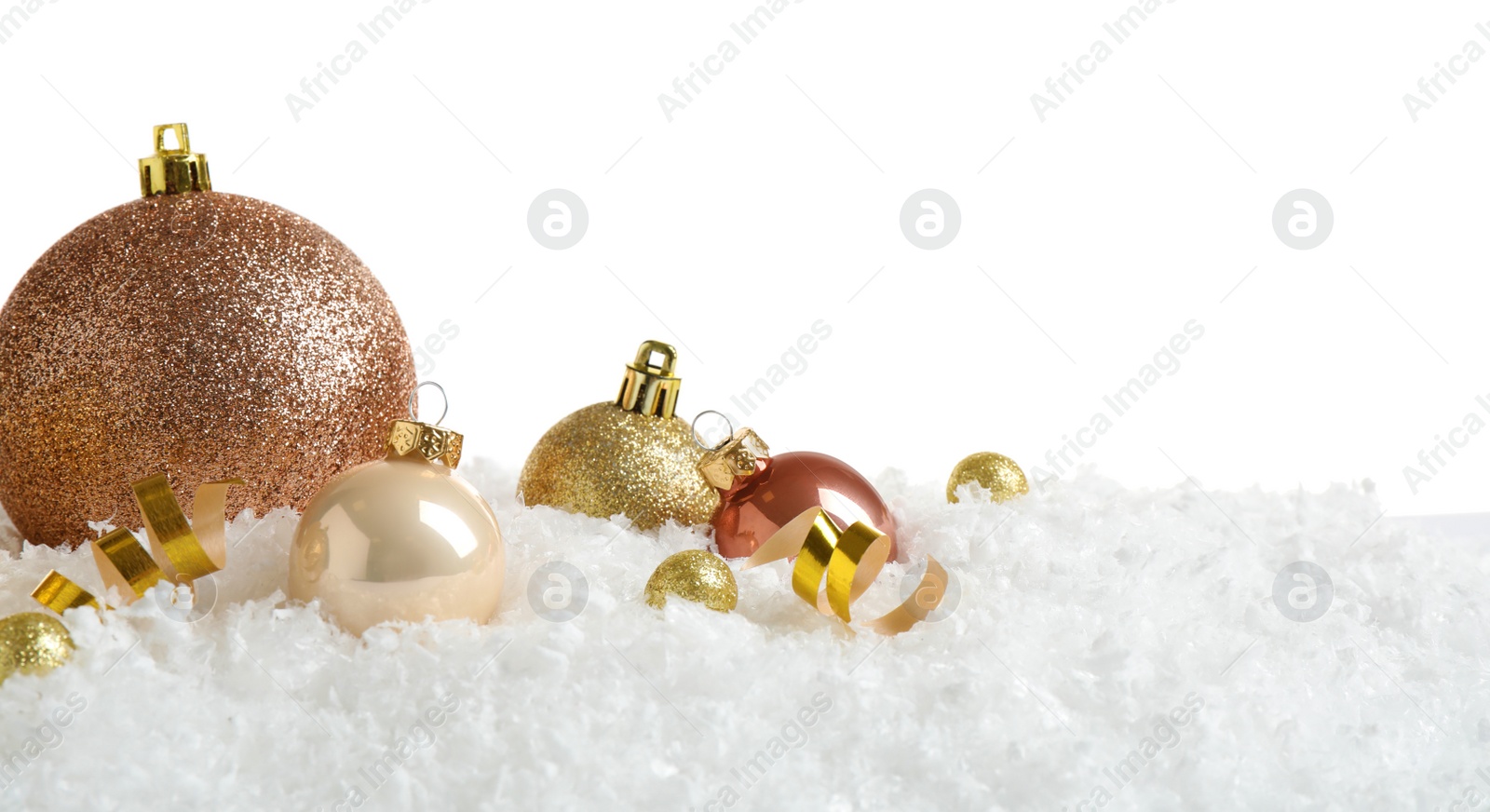 Photo of Christmas tree decoration on artificial snow against white background