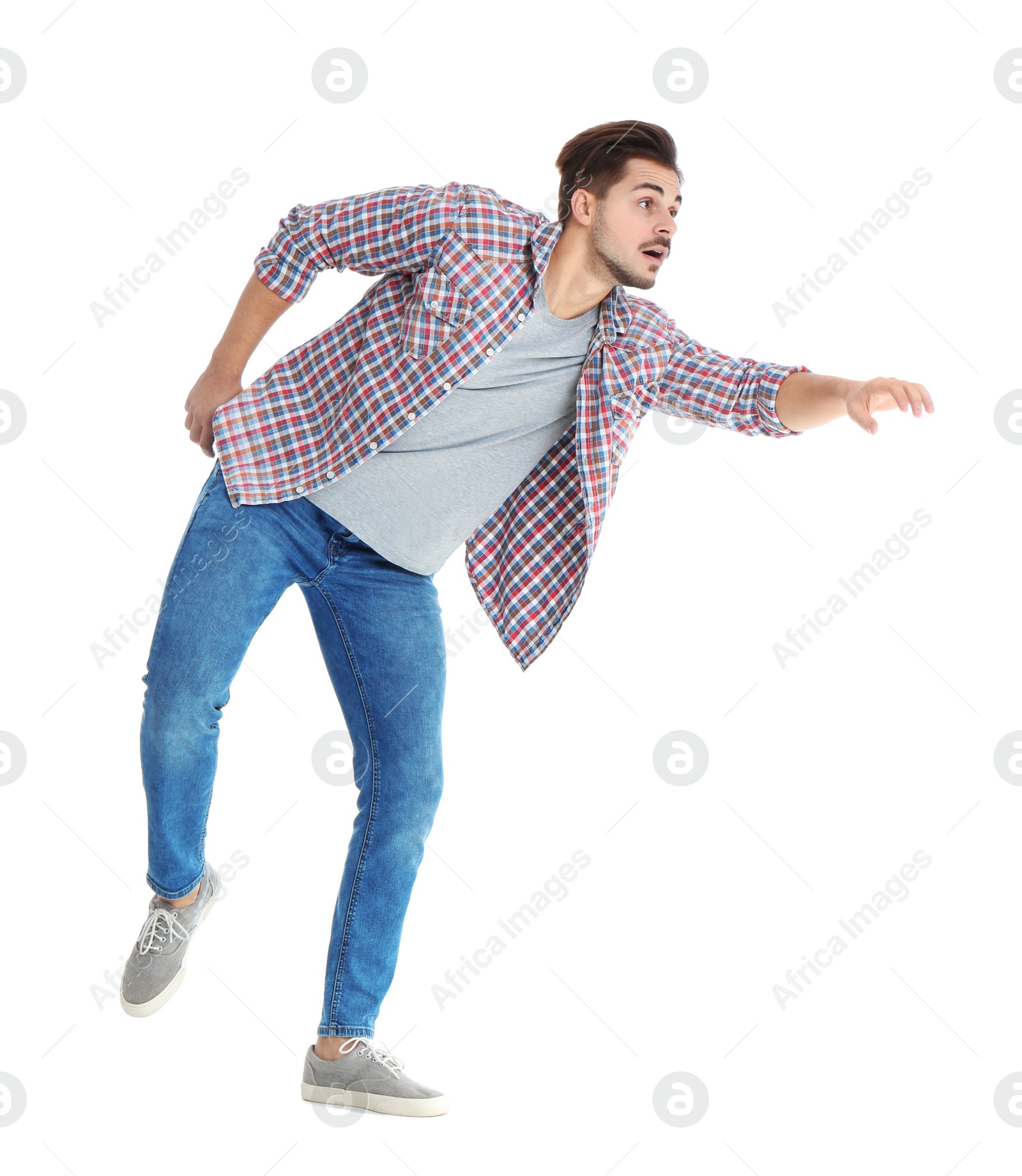 Photo of Young man attracted to magnet on white background